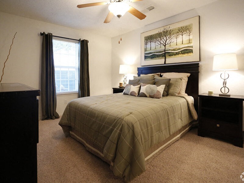 a bedroom with a bed and two night stands