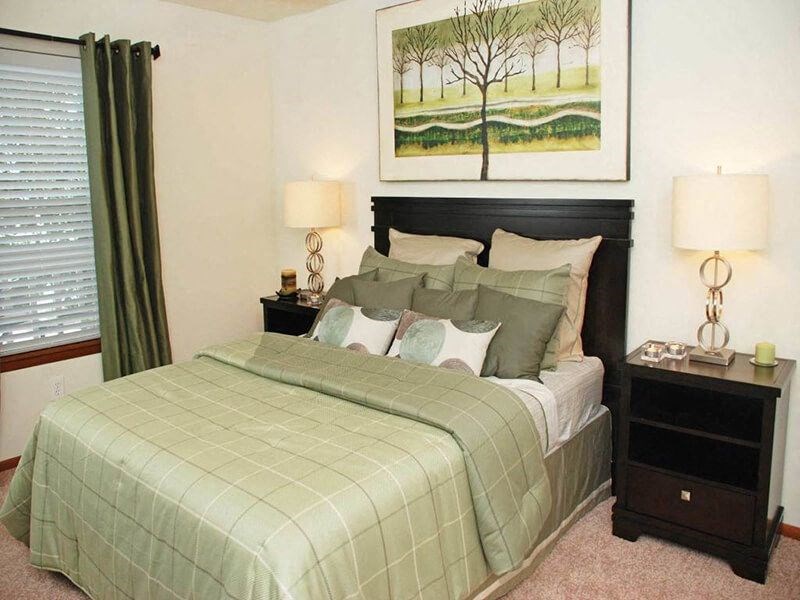 a bedroom with a bed and two nightstands