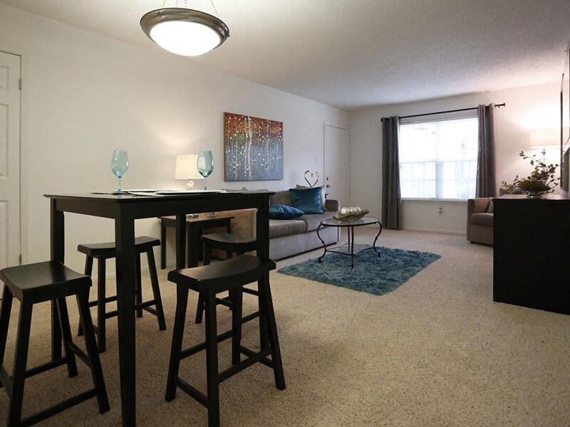a living room with a couch and a table with stools