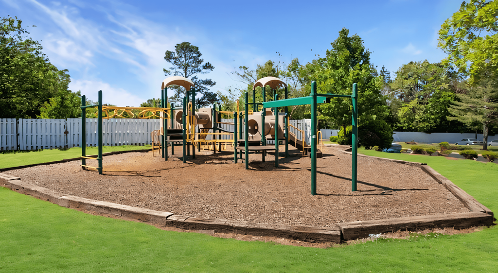 a playground with a swing set in a park