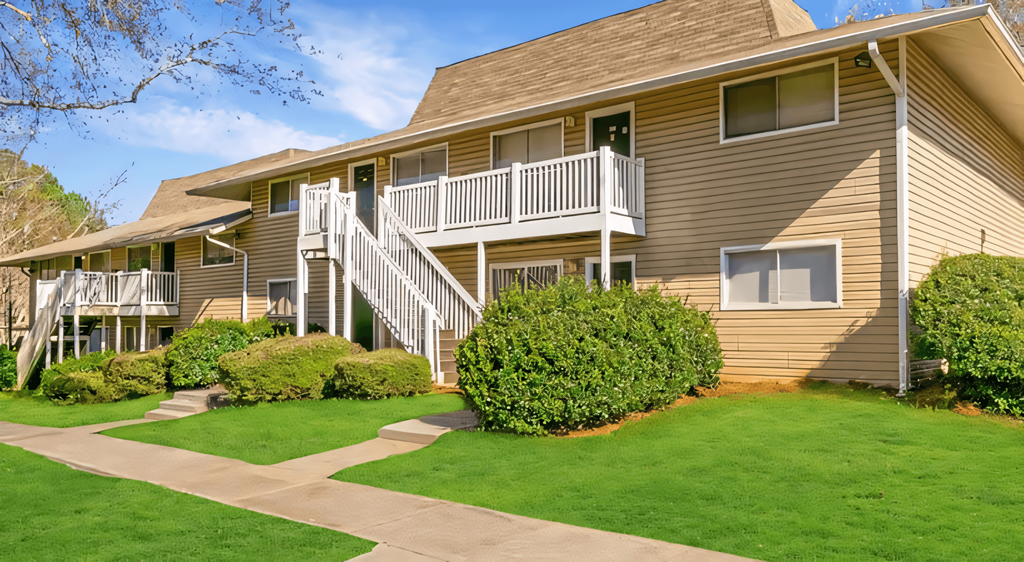 the front of a house with a porch and a staircase