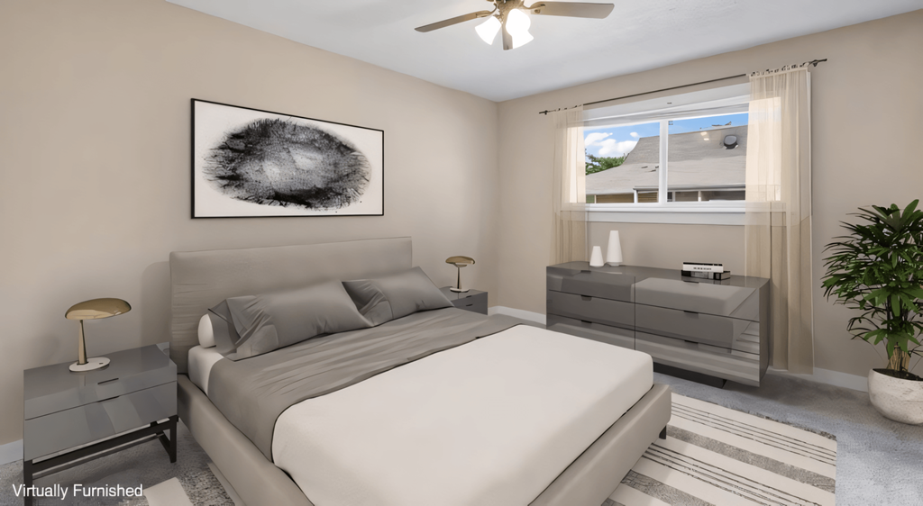a bedroom with a white bed and a ceiling fan