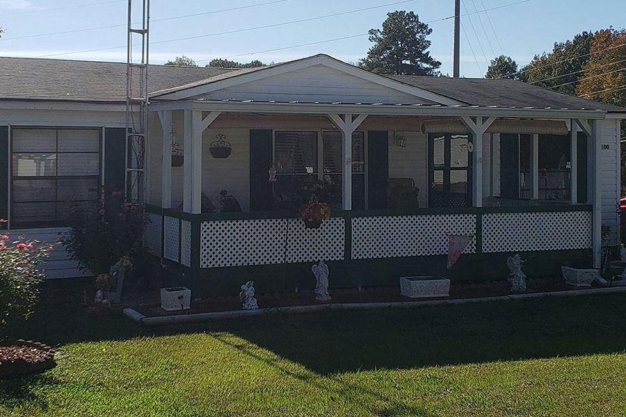 a house with a porch and a lawn