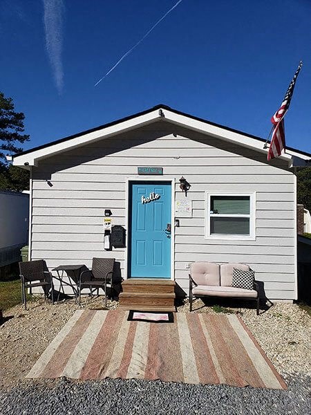 a small white house with a blue door