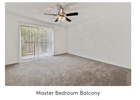 A master bedroom balcony with a fan and a window.