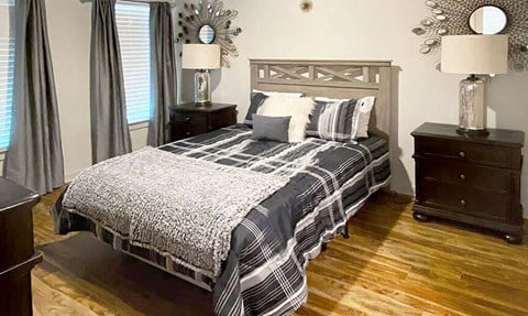 a bedroom with a bed and two night stands