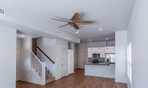 A modern open plan living area with a staircase.