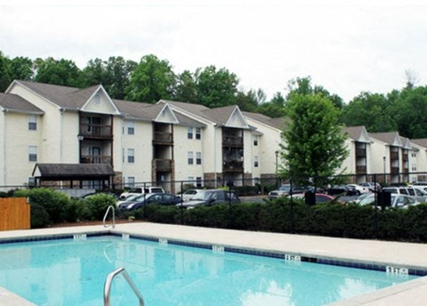 a large swimming pool in front of some apartment buildings