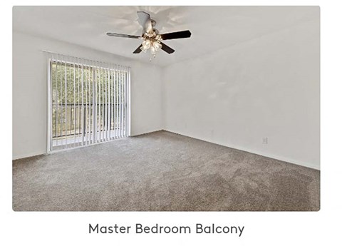 A spacious master bedroom balcony with a ceiling fan and a window with a metal grill.
