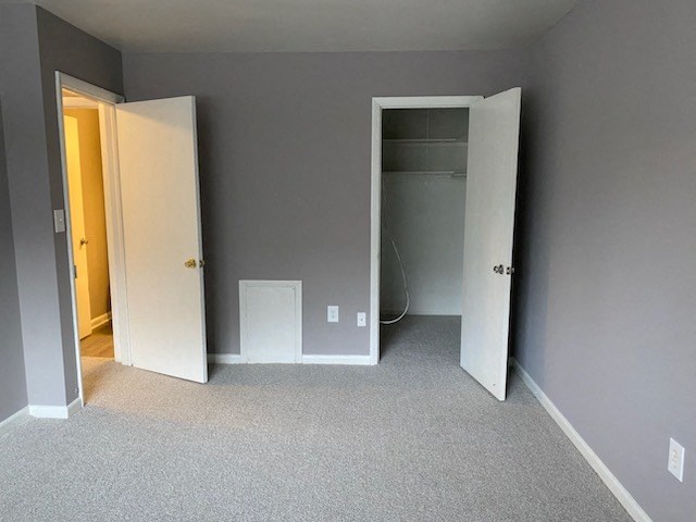 a bedroom with a closet and a door open