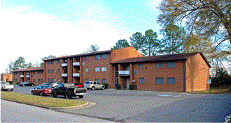 a large brick building with cars parked in front of it