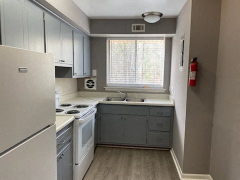 a kitchen with a stove a sink and a window