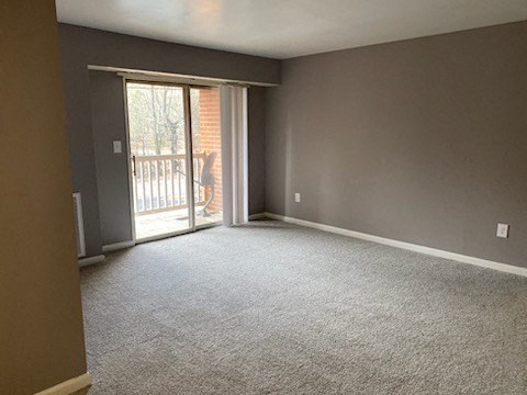 an empty living room with a sliding glass door