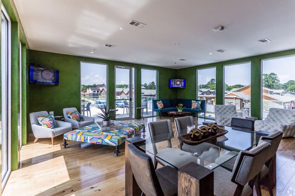 a living room filled with furniture and a large window