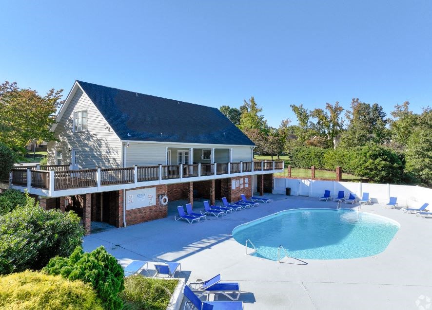 a house with a pool in front of it