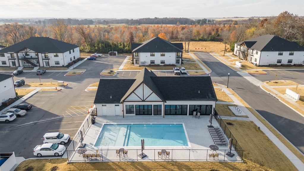 an aerial view of a building with a swimming pool