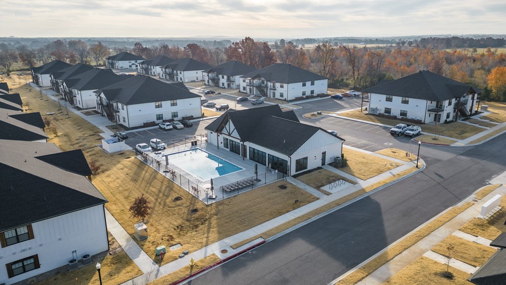 an aerial view of a neighborhood of houses with a swimming pool