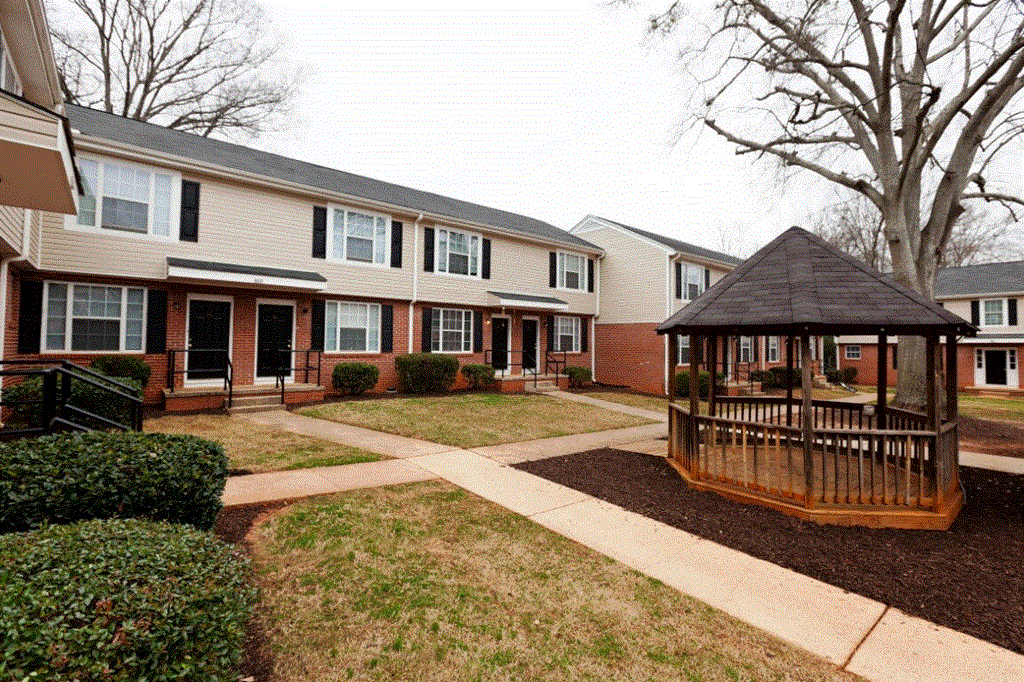 a gazebo in the front yard of an apartment complex