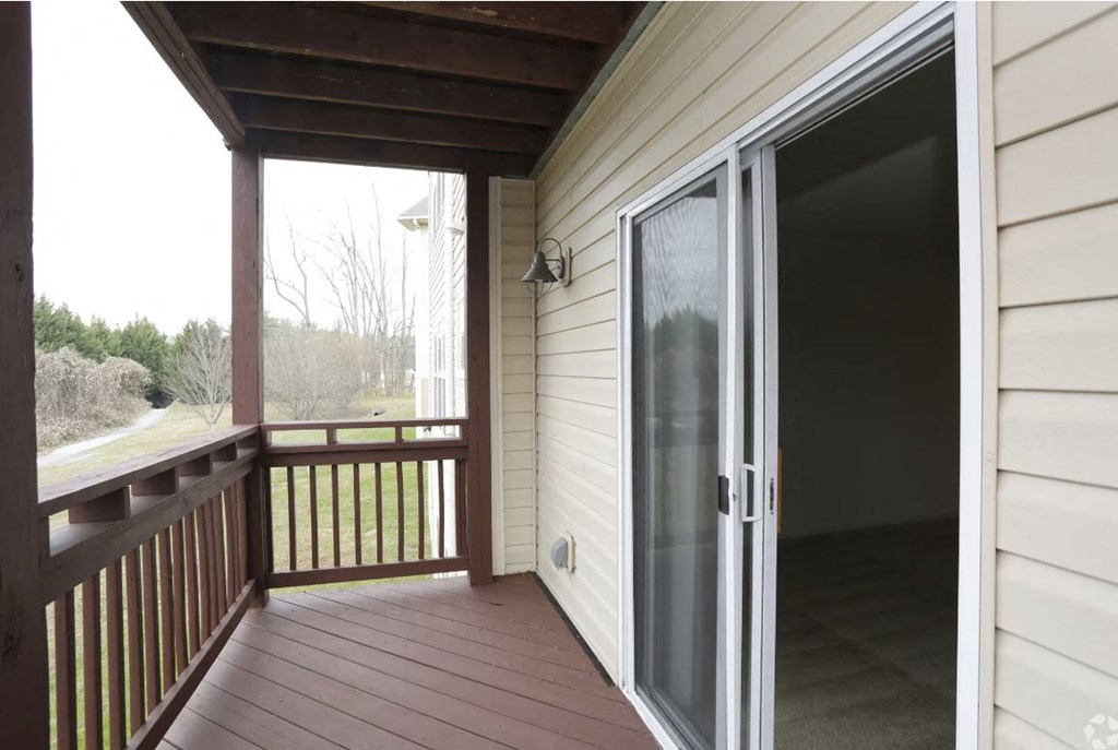 a screened in porch with a sliding glass door