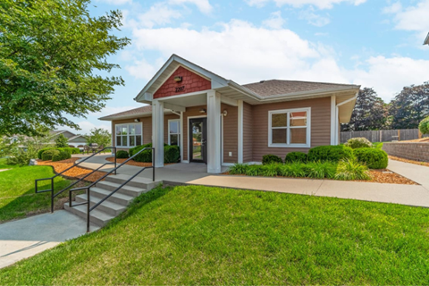 the front of a house with a porch and a walkway