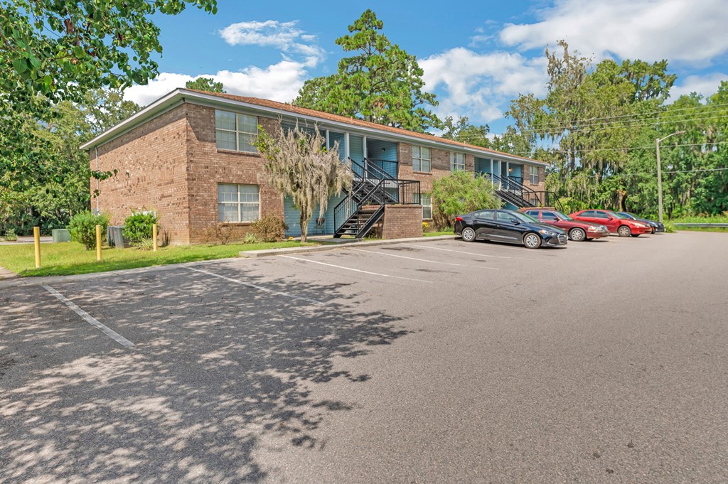 a brick building with cars parked in front of it