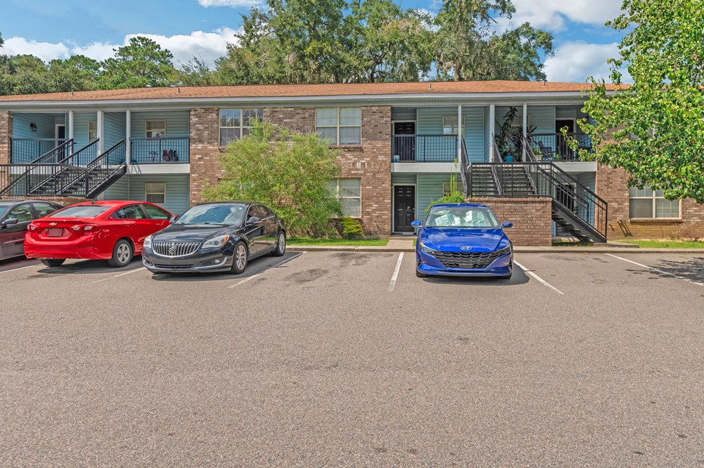 a parking lot with three cars in front of a building