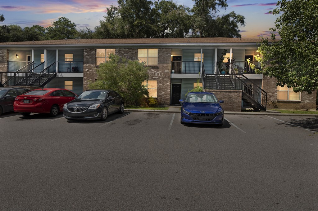 a parking lot with three cars in front of a building