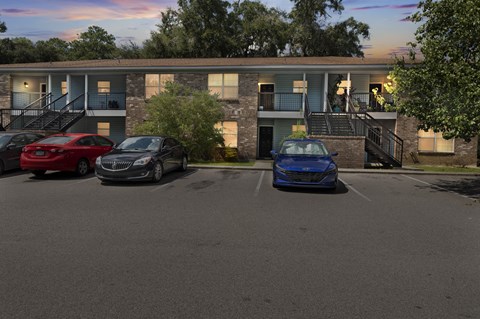A parking lot with cars and a building in the background.