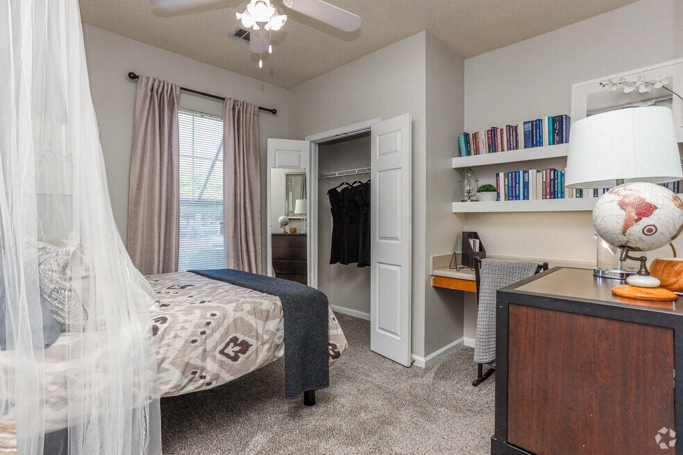 a bedroom with a bed and a dresser and a closet