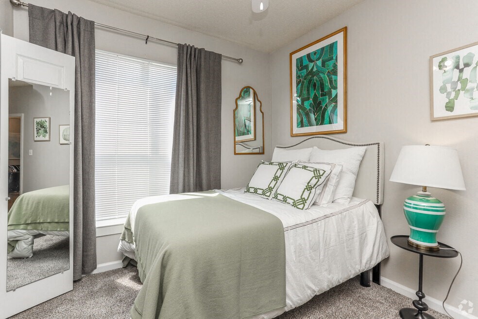 a bedroom with a bed and a mirror