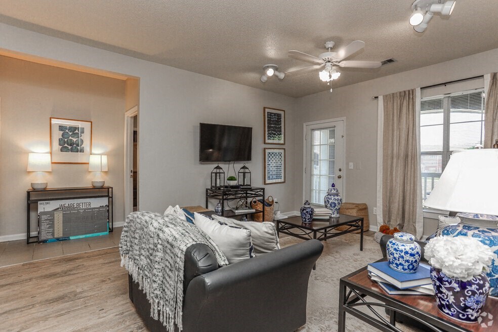 a living room with a couch and a ceiling fan