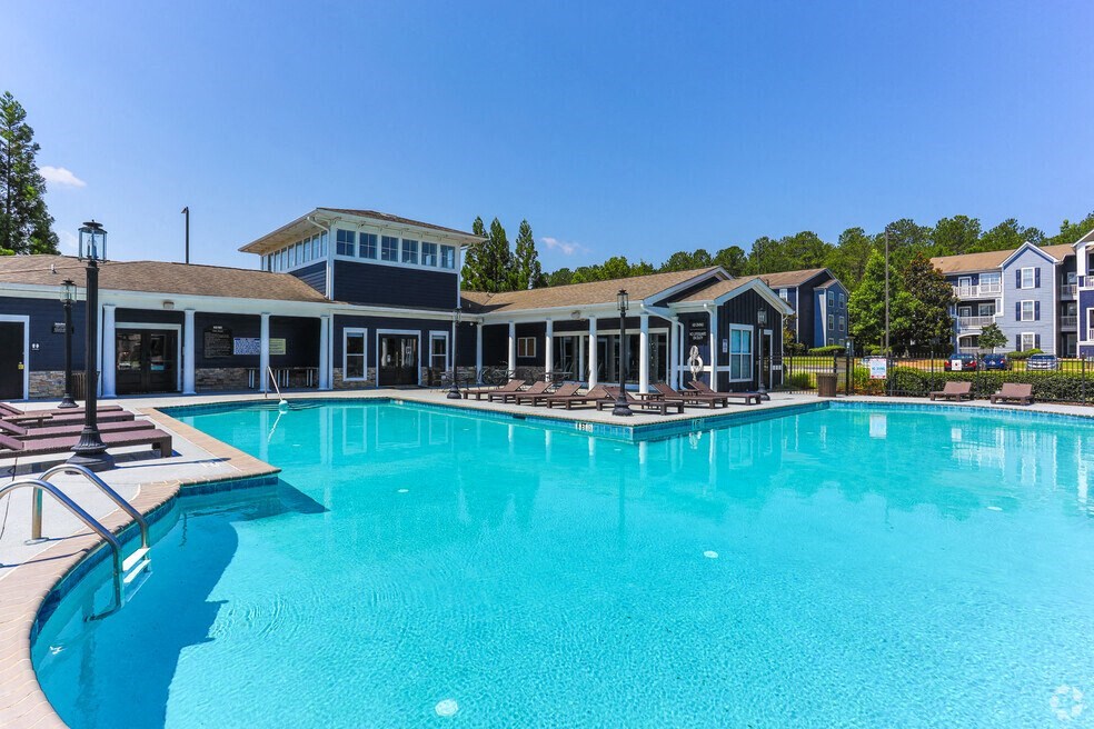 a large pool with a building in the background