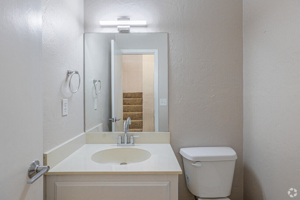 a bathroom with a sink and a mirror and a toilet