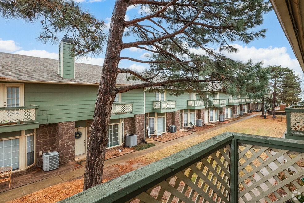 a view of a building from a balcony with a tree