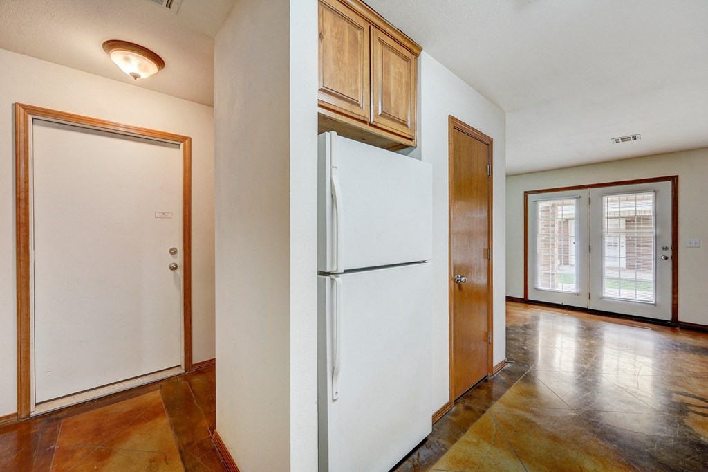 a kitchen with a refrigerator and a door
