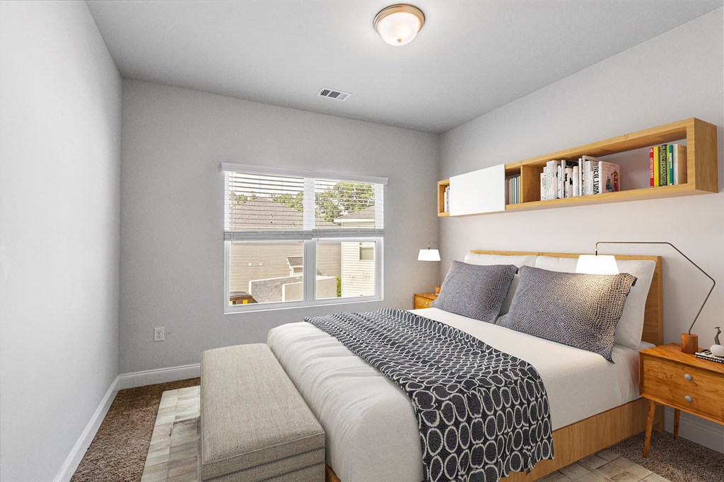 a bedroom with a large bed and a bench at the end of the bed