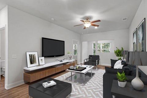 an open living room with a black couch and a tv