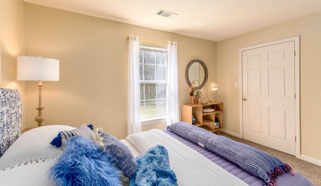 a bedroom with a large bed and a window