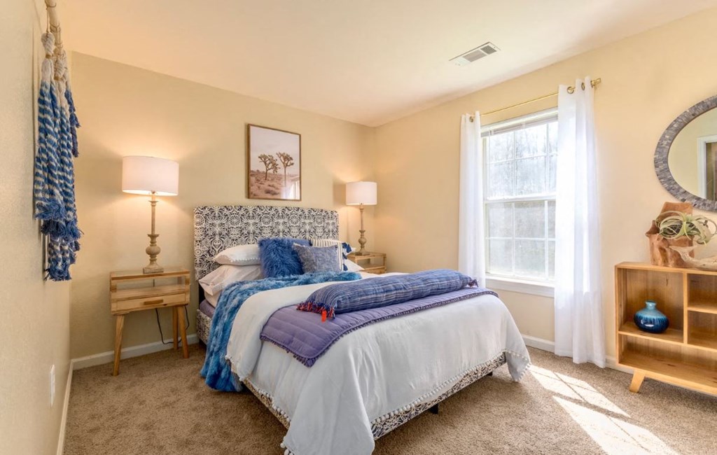 a bedroom with a bed and a window