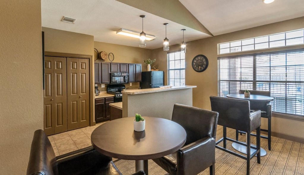 a dining room and kitchen with a table and chairs