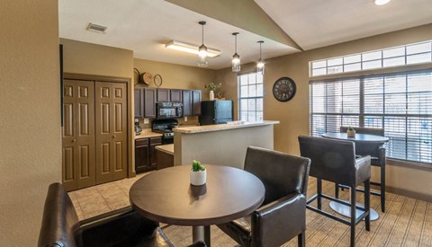 a dining room and kitchen with a table and chairs