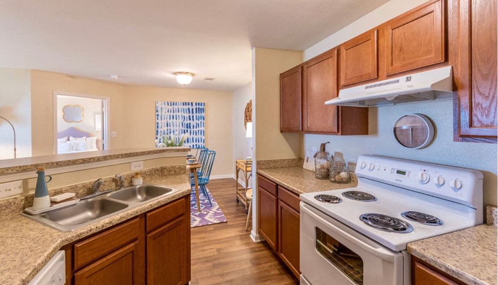 a kitchen with a stove top oven and a sink