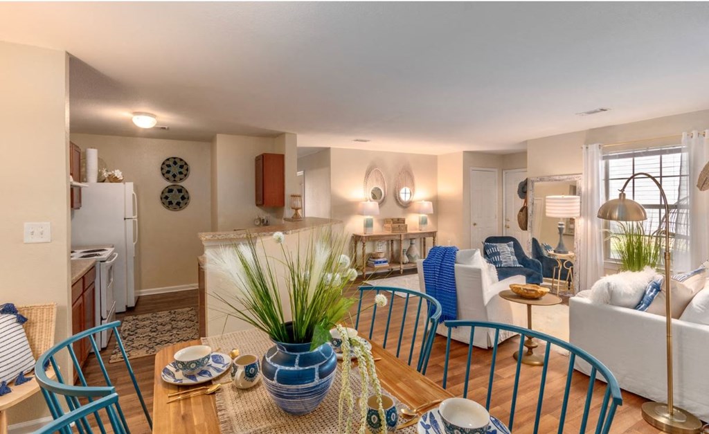 a living room and dining room with a table and chairs