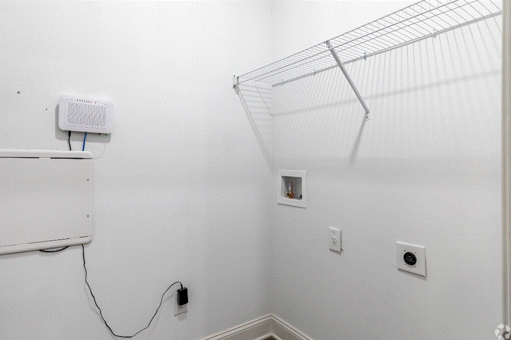 a room with white walls and a white shelf on the wall