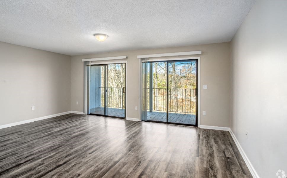 an empty living room with a sliding glass door