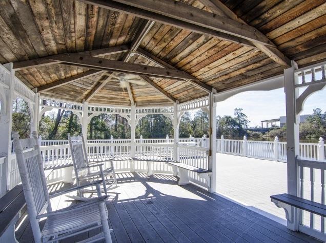 a porch with rocking chairs and a wooden roof