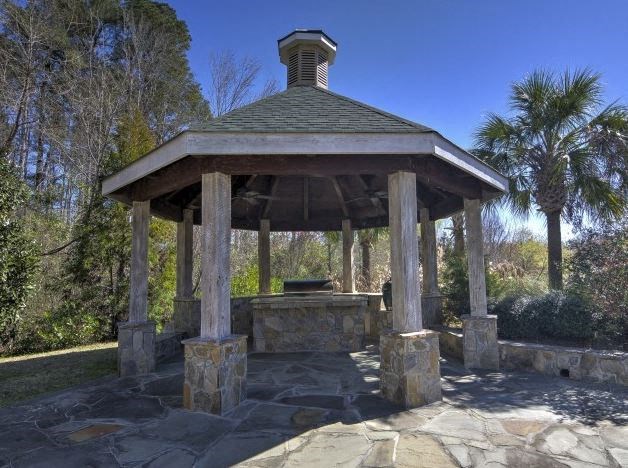 a gazebo with a fountain in a park