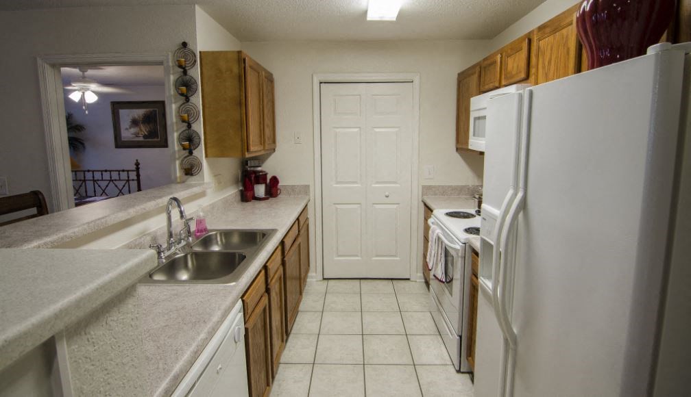 a kitchen with a sink and a refrigerator