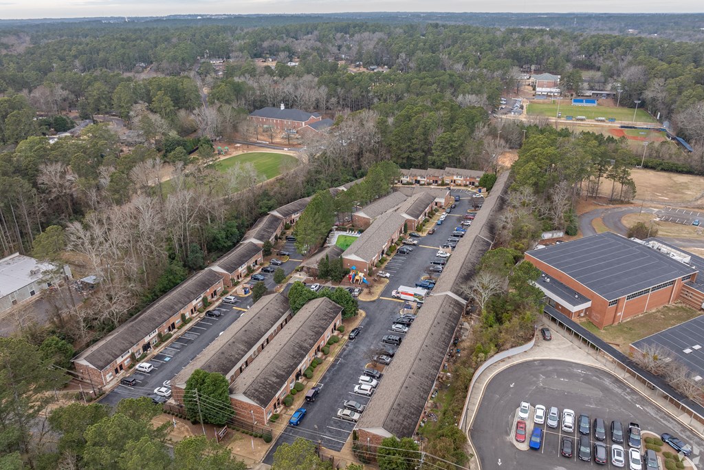 an aerial view of a train yard and parking lot