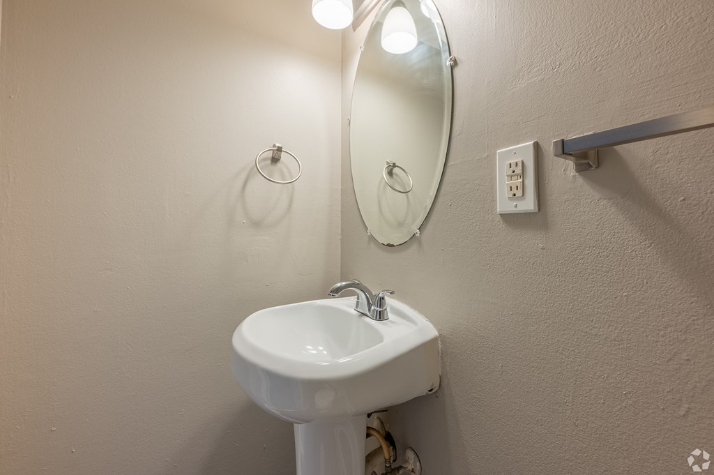 a small bathroom with a sink and a mirror